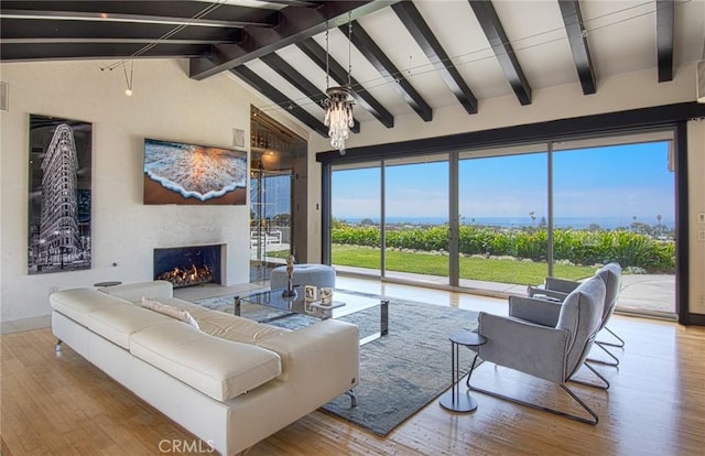 living room featuring vaulted ceiling with beams and light hardwood / wood-style flooring