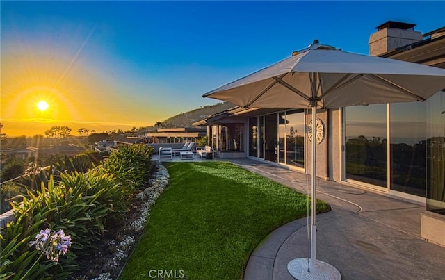 yard at dusk with a patio