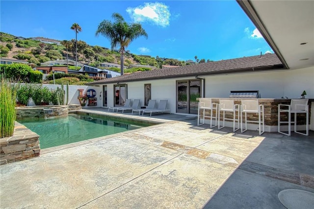 view of swimming pool with an in ground hot tub, a bar, and a patio