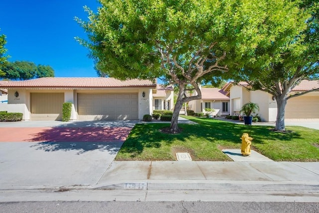 view of front of property featuring a garage and a front lawn