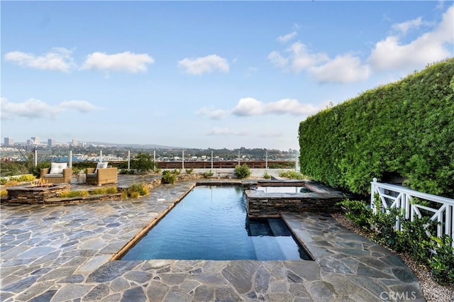 view of swimming pool with an in ground hot tub and a patio