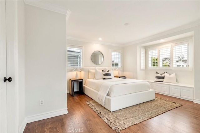 bedroom featuring hardwood / wood-style floors and crown molding