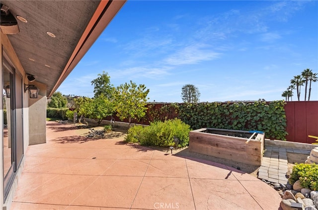 view of patio / terrace featuring a garden and a fenced backyard