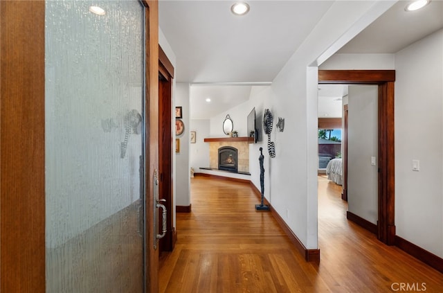 hall featuring recessed lighting, wood finished floors, and baseboards