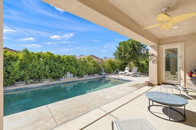 view of swimming pool featuring ceiling fan and a patio