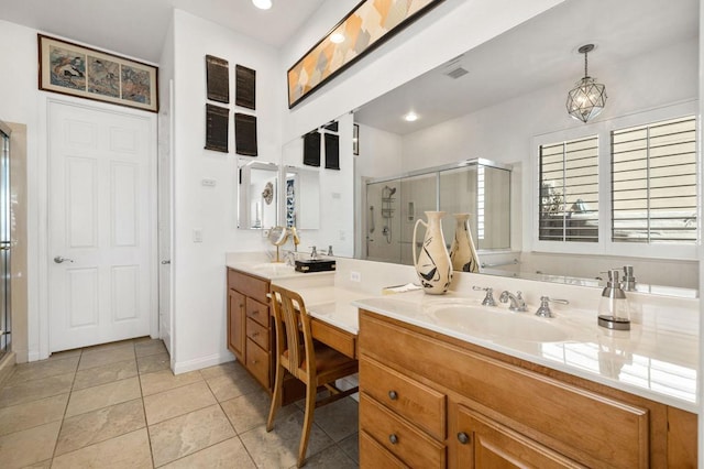 bathroom featuring tile patterned flooring, vanity, and a shower with door