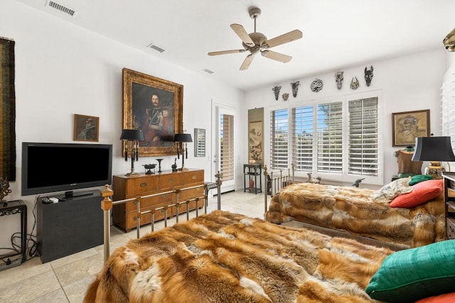 tiled bedroom featuring ceiling fan