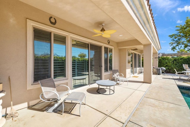 view of patio / terrace featuring ceiling fan and a swimming pool