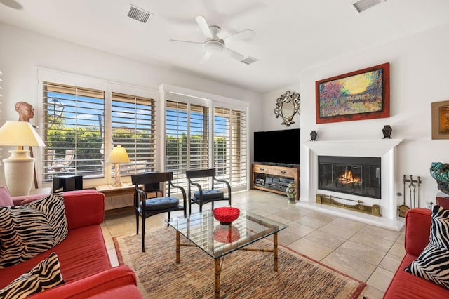 tiled living room with plenty of natural light and ceiling fan