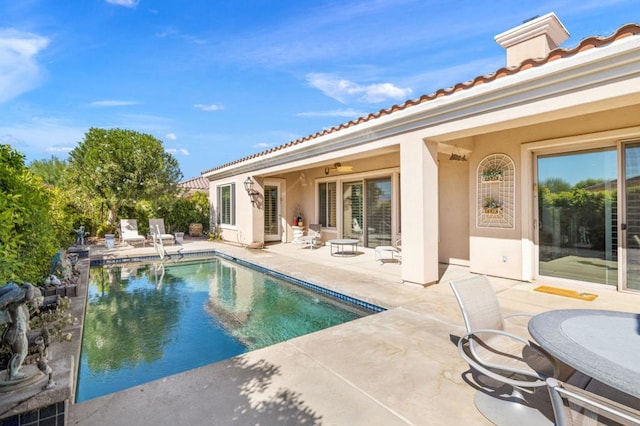 view of swimming pool featuring a patio area and ceiling fan