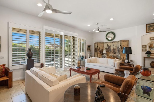 living room featuring light tile patterned floors and ceiling fan