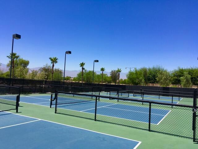 view of tennis court with basketball hoop