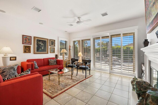 living room with ceiling fan and light tile patterned flooring