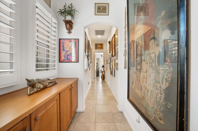 corridor featuring light tile patterned floors