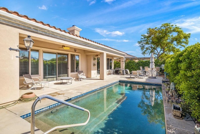 view of pool featuring ceiling fan and a patio area