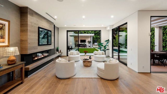 interior space with a tile fireplace and light hardwood / wood-style floors