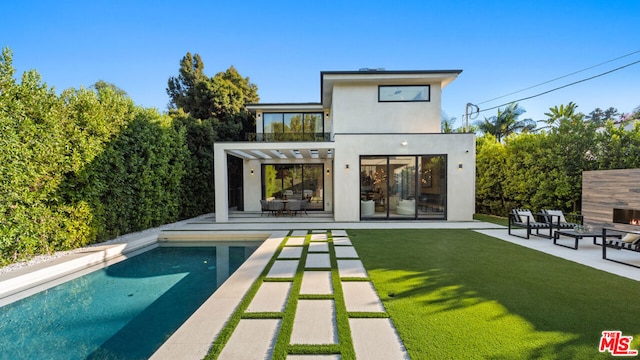 back of house with a yard, a pergola, and a patio