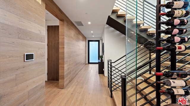 stairs with wood walls and wood-type flooring