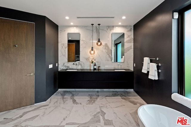 bathroom with vanity, a bathtub, and tasteful backsplash