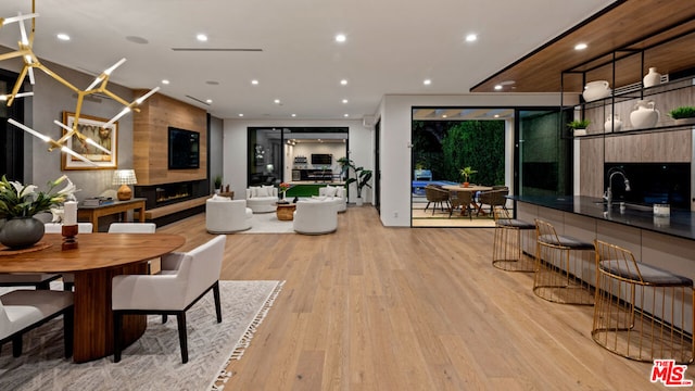 dining space featuring an inviting chandelier and light wood-type flooring