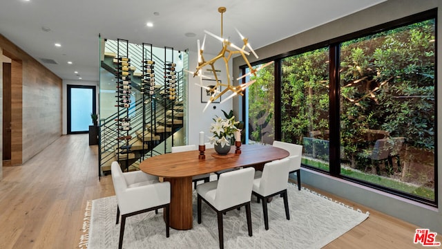 dining area featuring light hardwood / wood-style floors and a chandelier