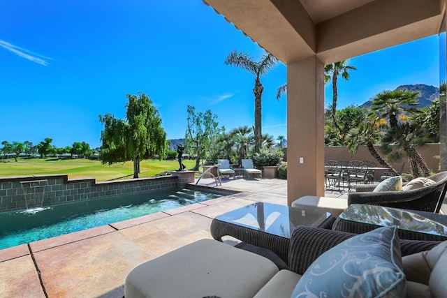 view of pool with pool water feature and a patio