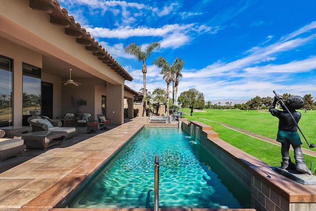 view of swimming pool with a lawn, a patio area, ceiling fan, and pool water feature