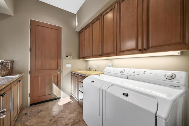 laundry room with washer and dryer, cabinets, and sink