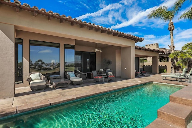 view of swimming pool featuring ceiling fan and a patio area