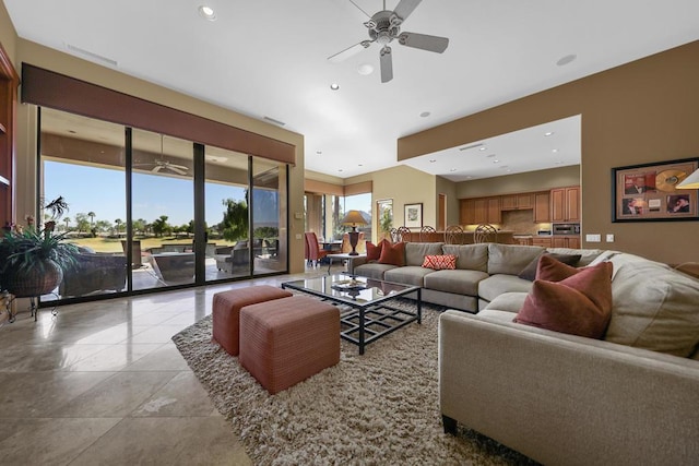 living room with ceiling fan and light tile patterned flooring