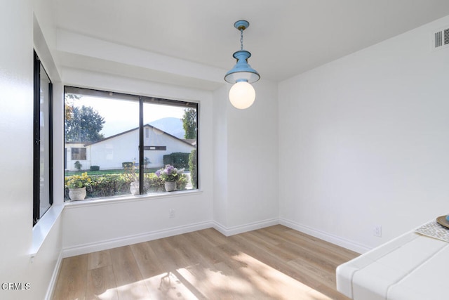 unfurnished dining area featuring light hardwood / wood-style floors