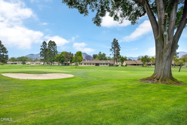 view of property's community with a yard and a mountain view