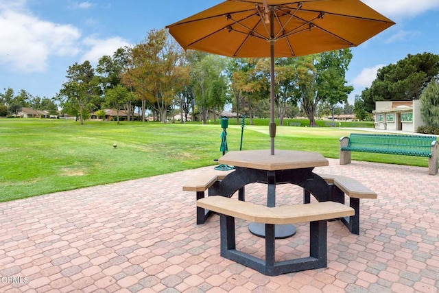 surrounding community featuring a lawn and a patio