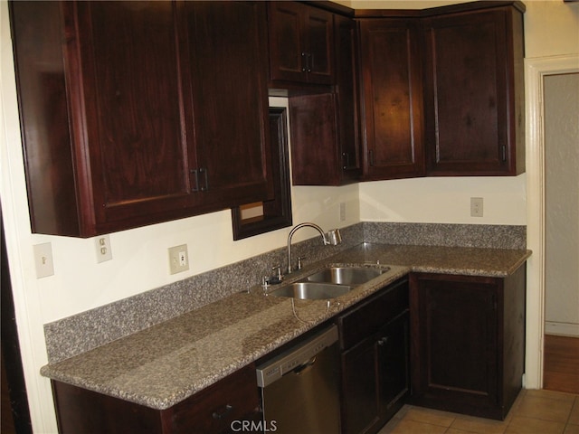 kitchen featuring dishwasher, light stone countertops, sink, and light tile patterned floors