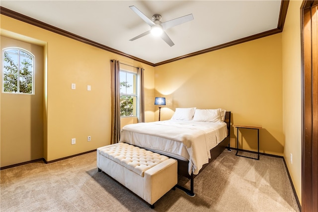 carpeted bedroom featuring ceiling fan and ornamental molding