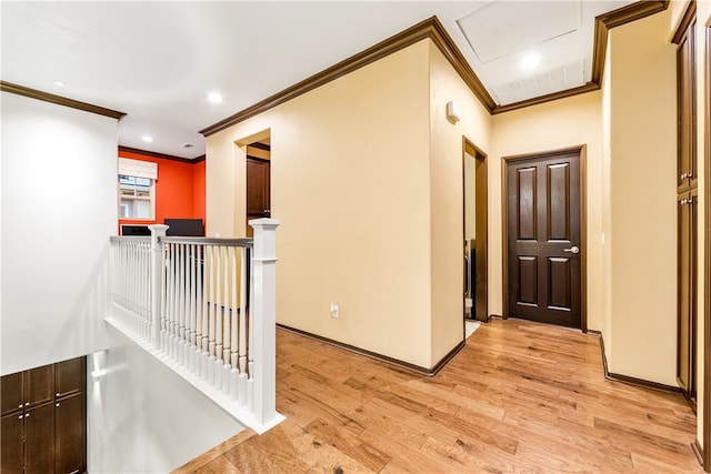 corridor with crown molding and light wood-type flooring