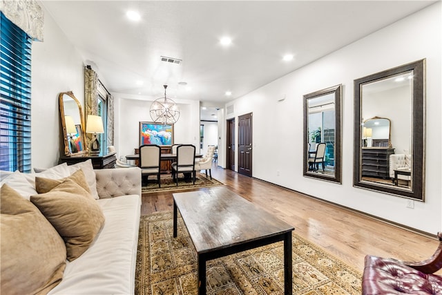 living room with a notable chandelier and hardwood / wood-style flooring