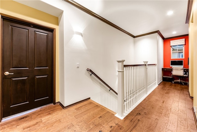 foyer entrance with crown molding and light hardwood / wood-style flooring