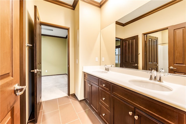 bathroom featuring vanity, crown molding, and tile patterned flooring