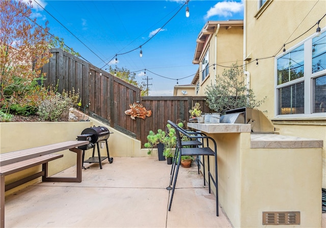 view of patio with area for grilling and an outdoor kitchen