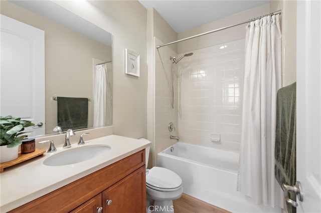 full bathroom with vanity, hardwood / wood-style flooring, toilet, and shower / bath combo with shower curtain