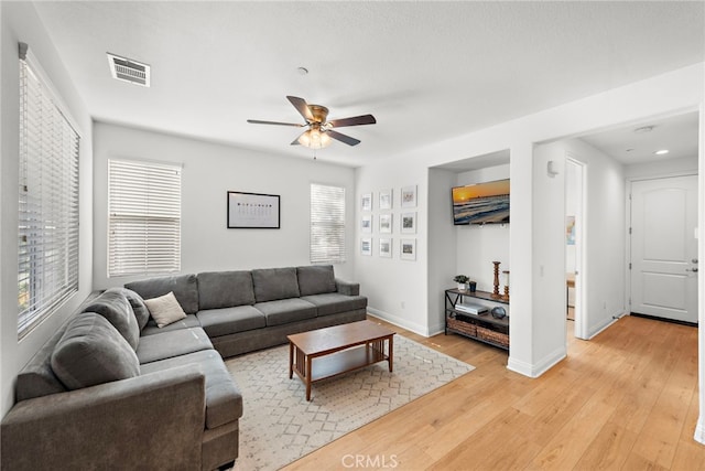 living room featuring ceiling fan and light wood-type flooring