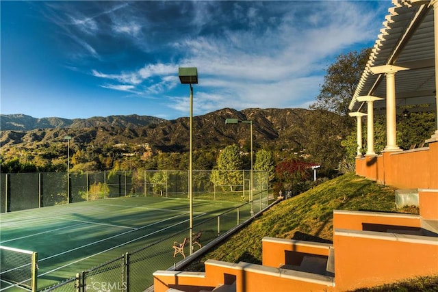 view of tennis court with a mountain view