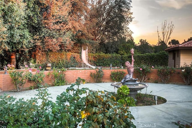 yard at dusk with a patio area