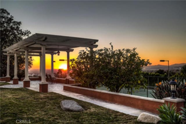 patio terrace at dusk with a pergola