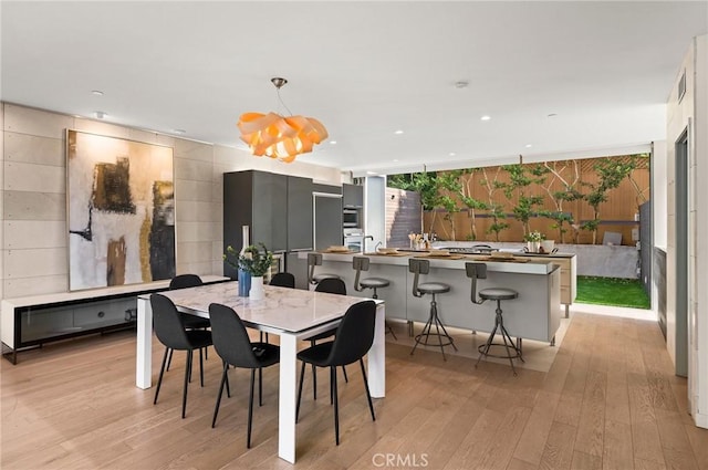 dining space with light hardwood / wood-style floors