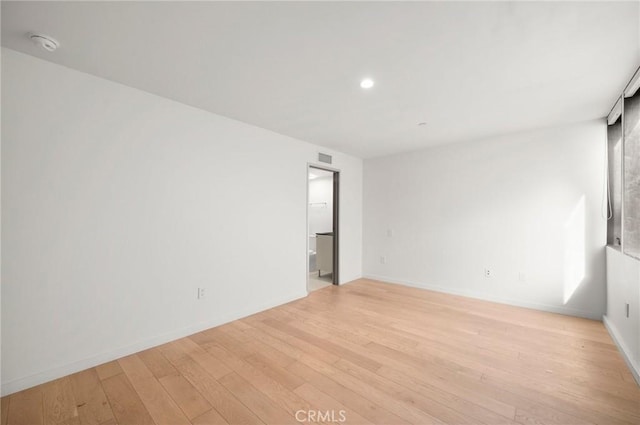 empty room with light hardwood / wood-style flooring