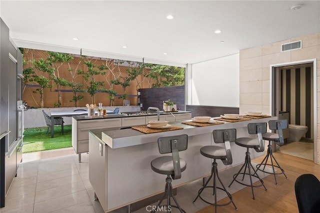 kitchen featuring a kitchen bar, a wealth of natural light, and a spacious island