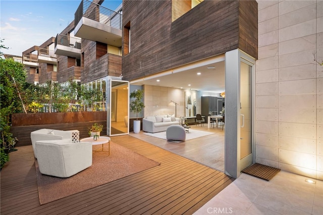 deck at dusk featuring an outdoor hangout area