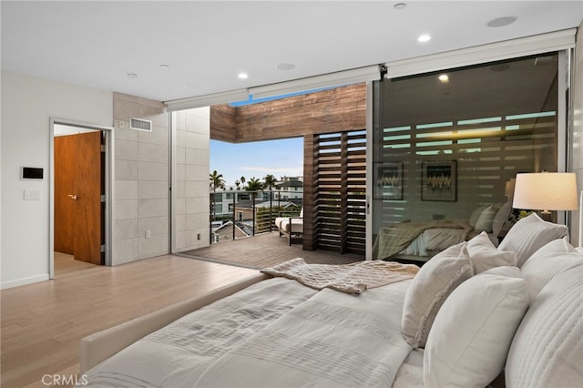 bedroom featuring access to exterior and light hardwood / wood-style flooring